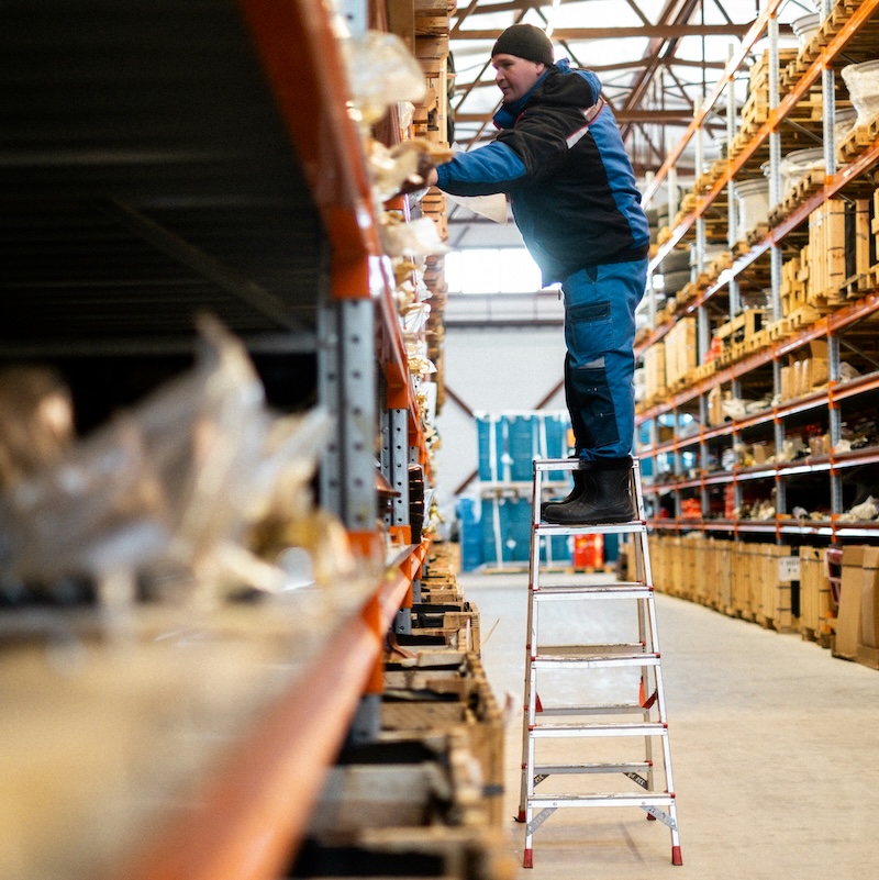 employee in moving boxes in warehouse